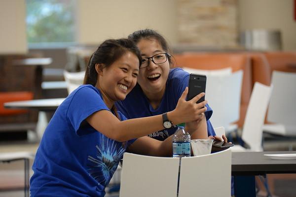 World language students looking at phone.